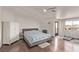 Comfortable primary bedroom with hardwood floors, ample natural light, and balcony access at 1436 Via Merano St, Henderson, NV 89052
