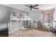 Bright bedroom with a unique loft bed, plush toys, and decorative curtains for a cozy and playful atmosphere at 1436 Via Merano St, Henderson, NV 89052