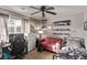Comfortable bedroom with a red loveseat, workspace, and decor for a relaxed and personalized space at 1436 Via Merano St, Henderson, NV 89052