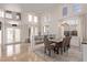 Bright and airy dining area with high ceilings, large windows, and chandelier lighting at 1436 Via Merano St, Henderson, NV 89052