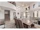 Open concept dining area featuring a modern chandelier, large windows, and travertine flooring at 1436 Via Merano St, Henderson, NV 89052