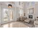 Elegant entryway with a statement front door, fireplace, and travertine flooring at 1436 Via Merano St, Henderson, NV 89052