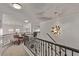 Upper-level hallway with decorative lighting, metal railings, and lounge chairs at 1436 Via Merano St, Henderson, NV 89052
