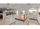 Open-concept kitchen with double islands and seating, flowing into the adjacent living area at 1436 Via Merano St, Henderson, NV 89052