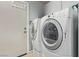 Bright laundry room featuring a modern washer and dryer set and convenient storage at 1436 Via Merano St, Henderson, NV 89052