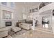 The grand living room has soaring ceilings, a fireplace, and an open floor plan at 1436 Via Merano St, Henderson, NV 89052