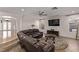 Open living room with hardwood floors, large TV, and comfortable seating area at 1436 Via Merano St, Henderson, NV 89052
