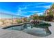 Scenic backyard pool with rock features and views of the surrounding landscape at 1436 Via Merano St, Henderson, NV 89052