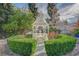 Well-manicured backyard with a white gazebo and lush landscaping at 208 Stonewood, Las Vegas, NV 89107