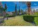 Lush backyard with green grass, mature trees, and a charming gazebo at 208 Stonewood, Las Vegas, NV 89107