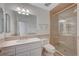 This bathroom features a vanity, toilet, and a glass-enclosed shower, showcasing functionality at 208 Stonewood, Las Vegas, NV 89107
