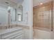 Bathroom featuring a vanity with sink and a shower-tub combo with glass doors at 208 Stonewood, Las Vegas, NV 89107