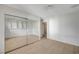 This minimalist bedroom showcases wood floors, sliding glass mirror doors, and a white door at 208 Stonewood, Las Vegas, NV 89107