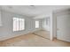 Minimalist bedroom showcasing wood floors, sliding glass mirror doors, and a white door at 208 Stonewood, Las Vegas, NV 89107