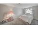 Cozy bedroom with a plush bed, chair and a decorative lamp on a table at 208 Stonewood, Las Vegas, NV 89107