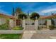 A charming walkway leads to the home's entrance, framed by manicured greenery and a decorative gate at 208 Stonewood, Las Vegas, NV 89107