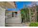Exterior side view showing a white shed, a window, and a decorative wooden garden arch at 208 Stonewood, Las Vegas, NV 89107