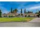 Expansive front yard view of a single story home with lush landscaping and a circular driveway at 208 Stonewood, Las Vegas, NV 89107