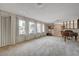 Bright living room featuring neutral tones, large windows with elegant drapery, and a decorative room divider at 208 Stonewood, Las Vegas, NV 89107