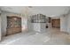 Spacious living area with ornate chandelier, decorative wall treatments, and seamless flow into the adjacent kitchen at 208 Stonewood, Las Vegas, NV 89107