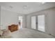 Bright living room features plush carpet, double doors to the backyard, and access to another room with a fireplace at 208 Stonewood, Las Vegas, NV 89107