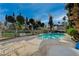 Inviting pool area featuring patio chairs and lush greenery, perfect for outdoor relaxation at 208 Stonewood, Las Vegas, NV 89107