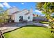 Landscaped backyard features a patio, seating, and a well-maintained lawn at 2108 Running River Rd, Henderson, NV 89074