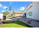 Well-manicured backyard featuring green grass, stone landscaping, and a patio with seating at 2108 Running River Rd, Henderson, NV 89074