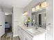 Bright bathroom with a white double vanity, large mirror, and modern fixtures at 2108 Running River Rd, Henderson, NV 89074