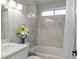 Bright bathroom featuring a shower with modern tile surround and a white shower curtain at 2108 Running River Rd, Henderson, NV 89074