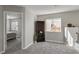Bright room with gray walls, carpet, and a bookshelf, offering a quiet space for reading and relaxing at 2108 Running River Rd, Henderson, NV 89074
