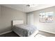 Bedroom featuring a comfortable bed, modern light fixture, and a window with outside views at 2108 Running River Rd, Henderson, NV 89074