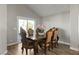 Elegant dining room with wood floors, a classic table set, and sliding glass doors to the outdoor patio at 2108 Running River Rd, Henderson, NV 89074