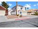 Charming two-story home with a well-manicured front yard and tile roof in a friendly neighborhood at 2108 Running River Rd, Henderson, NV 89074