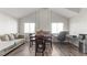 Bright living area featuring wood floors, comfortable seating, dining area, and a dedicated workspace at 2108 Running River Rd, Henderson, NV 89074