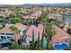 Aerial view showcases landscaped backyard with pool; features a tile roof and manicured greenery at 2508 Monarch Bay Dr, Las Vegas, NV 89128