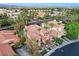 Stunning aerial view highlighting the backyard oasis with pool, mature trees, and decorative tile roof at 2508 Monarch Bay Dr, Las Vegas, NV 89128