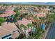 Aerial view of the property showcasing backyard pool, mature landscaping and tile roof in a tree-lined neighborhood at 2508 Monarch Bay Dr, Las Vegas, NV 89128