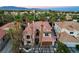 Aerial view of a luxurious home showcasing a red-tiled roof and desert landscaping at 2508 Monarch Bay Dr, Las Vegas, NV 89128