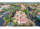 Scenic aerial view of a landscaped property with a backyard pool, mature trees, and a classic tile roof at 2508 Monarch Bay Dr, Las Vegas, NV 89128