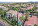 Aerial view of a beautiful home with a private pool, lush landscaping, and tile roof in an upscale neighborhood at 2508 Monarch Bay Dr, Las Vegas, NV 89128