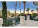 Balcony overlooking the street featuring lush landscaping and desert trees at 2508 Monarch Bay Dr, Las Vegas, NV 89128