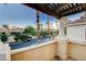 Balcony view with pergola, showcasing the neighborhood with palm tree landscaping at 2508 Monarch Bay Dr, Las Vegas, NV 89128