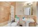 Bathroom features a tub-shower combo with tile walls and a pedestal sink at 2508 Monarch Bay Dr, Las Vegas, NV 89128