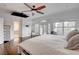 Bright bedroom features balcony access, ceiling fan and hardwood flooring at 2508 Monarch Bay Dr, Las Vegas, NV 89128