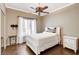 Cozy bedroom features hardwood floors, ceiling fan, and closet with mirror doors at 2508 Monarch Bay Dr, Las Vegas, NV 89128