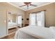 Cozy bedroom features hardwood floors, ceiling fan, and closet with mirror doors at 2508 Monarch Bay Dr, Las Vegas, NV 89128