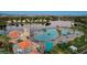 Aerial image of a community pool, showcasing clear water, sandy beach, and surrounding landscaping and buildings at 2508 Monarch Bay Dr, Las Vegas, NV 89128