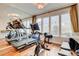 Bright exercise room with wood floors, mirrored wall, and an array of exercise equipment at 2508 Monarch Bay Dr, Las Vegas, NV 89128