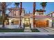 Elegant two-story stucco home featuring a red tile roof, gated entry, and a spacious two-car garage at 2508 Monarch Bay Dr, Las Vegas, NV 89128